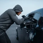 robber stealing handbag parked car