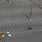 three cars in empty lot