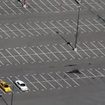 three cars in empty lot