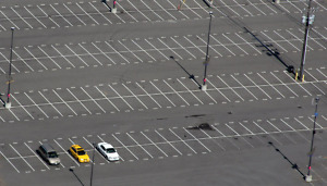 three cars in empty lot