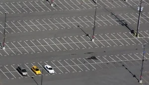 three cars in empty lot