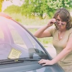unhappy woman looking at parking ticket