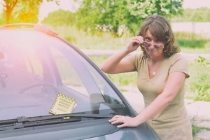 unhappy woman looking at parking ticket