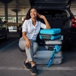frictionless parking women sitting on suitcase