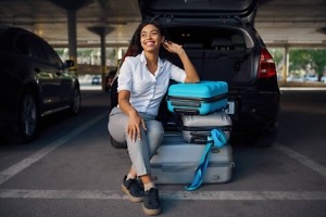frictionless parking women sitting on suitcase