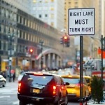 Roadsign,In,New,York.,Cars,,Taxi,Cabs,And,People,Rushing
