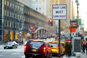 Roadsign,In,New,York.,Cars,,Taxi,Cabs,And,People,Rushing