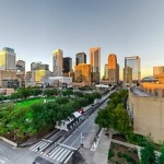 Aerial,View,Downtown,Houston,Illuminated,At,Sunset,With,Green,City