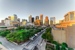 Aerial,View,Downtown,Houston,Illuminated,At,Sunset,With,Green,City