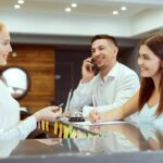 Couple,Near,Reception,Desk,In,Hotel